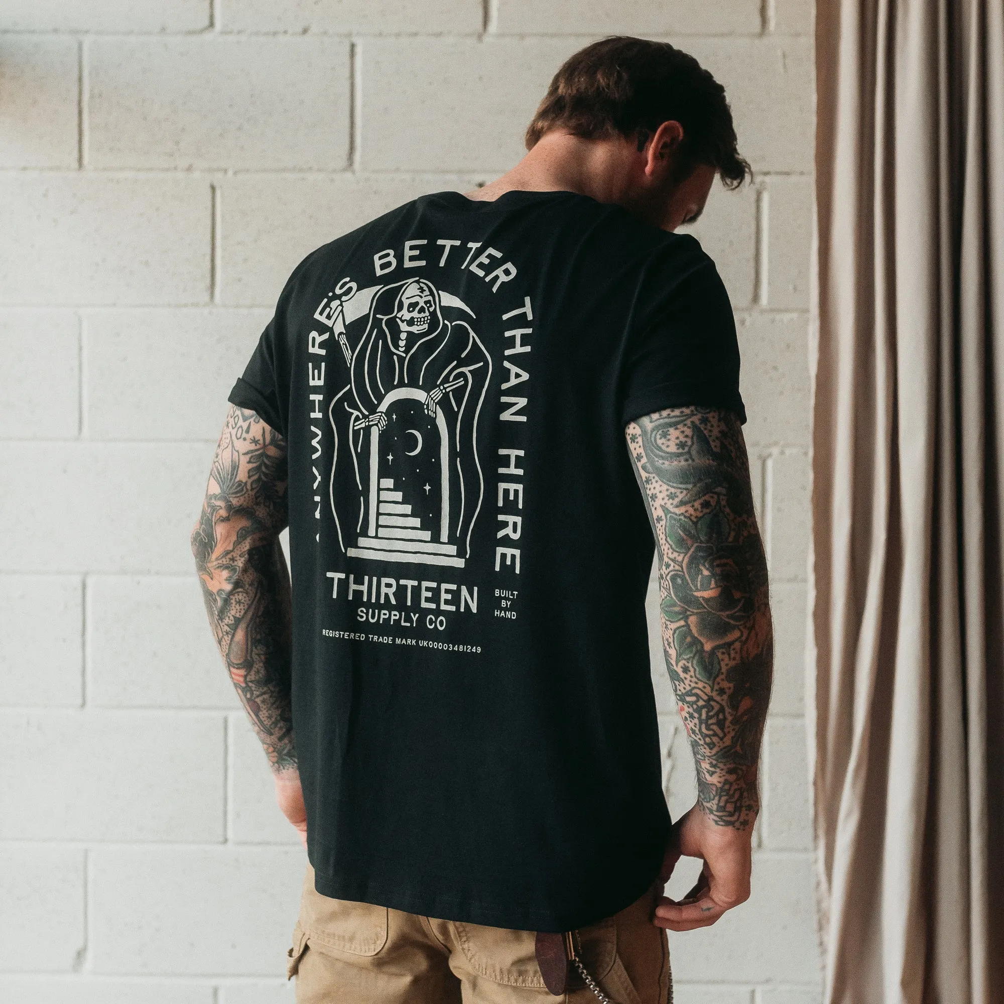 ANYWHERE'S BETTER THAN HERE - BLACK UNISEX T-SHIRT